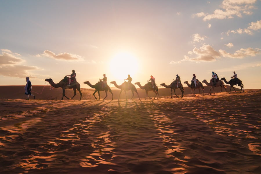 Camel caravan in the sunset at the Sahara Desert of Merzouga Morocco Itinerary