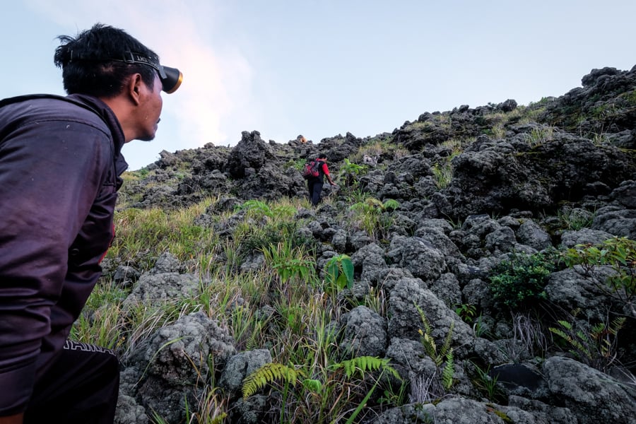 Local Hiker Guides Climbing Mount Karangetang In Siau Sulawesi Indonesia