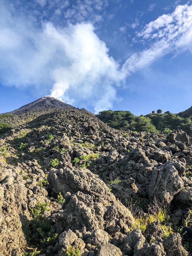 Smoking crater summit and old lava field