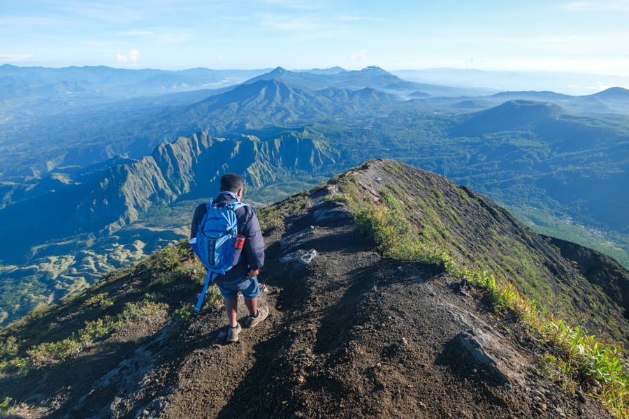 Trekking guide walking down from the summit of Mount Inerie