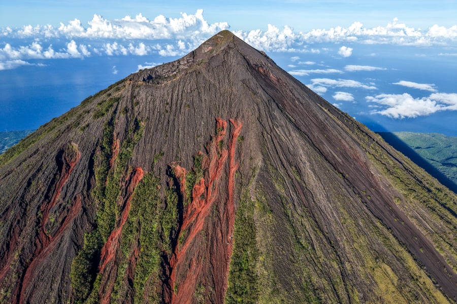 Volcano drone view with red rocks on the slopes of the mountain
