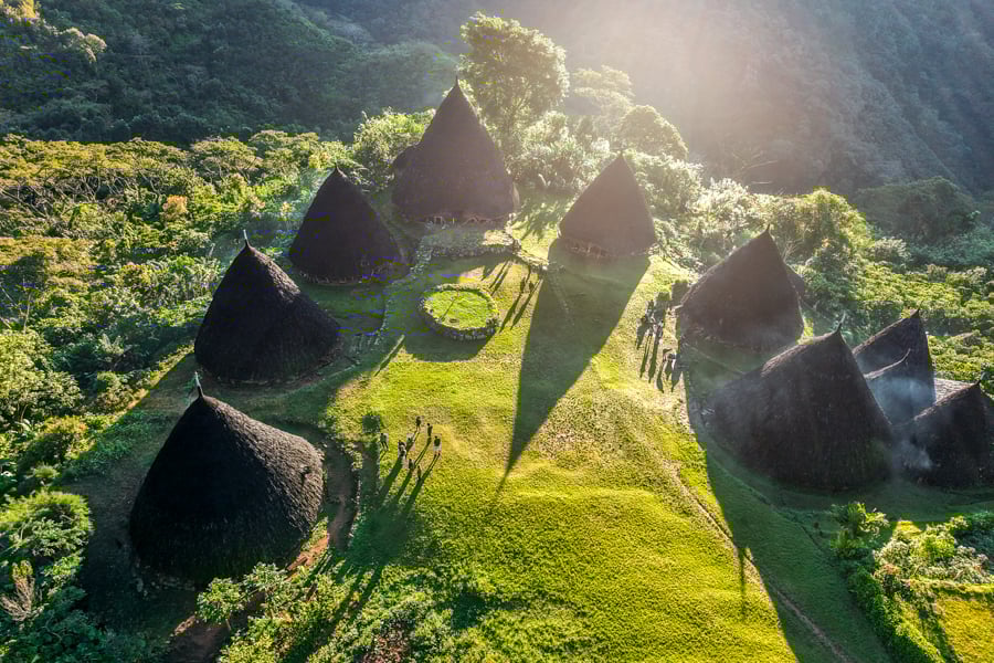 Village casting long shadows in the sunrise drone