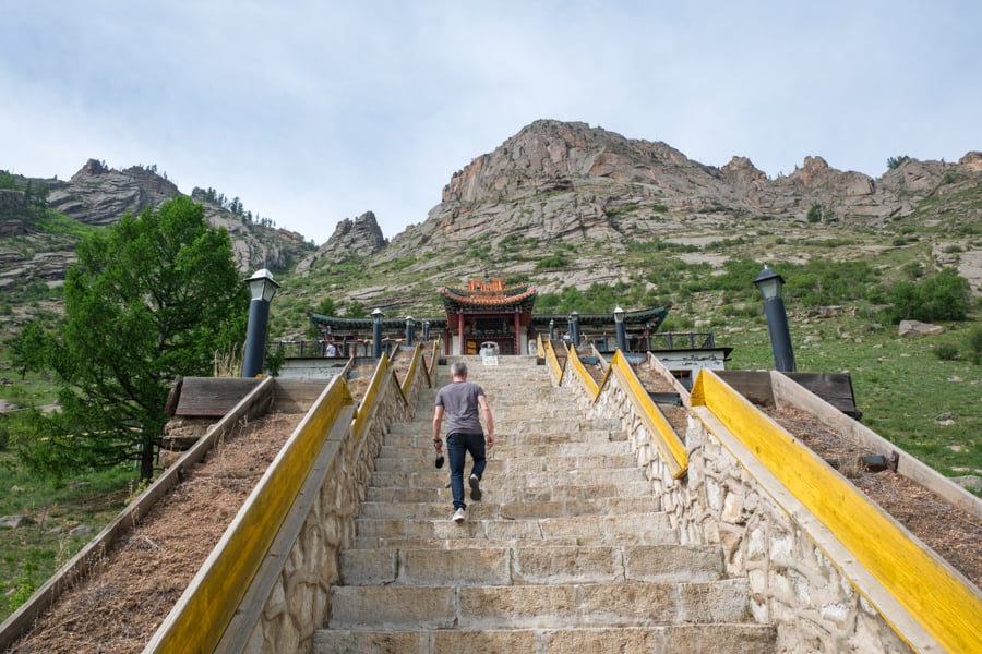 Tourist climbing the steps to the Aryapala monastery