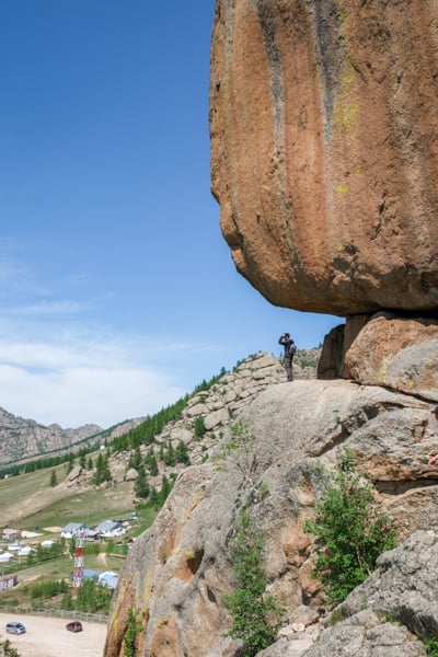 Tourist on top of Turtle Rock in Terelj National Park