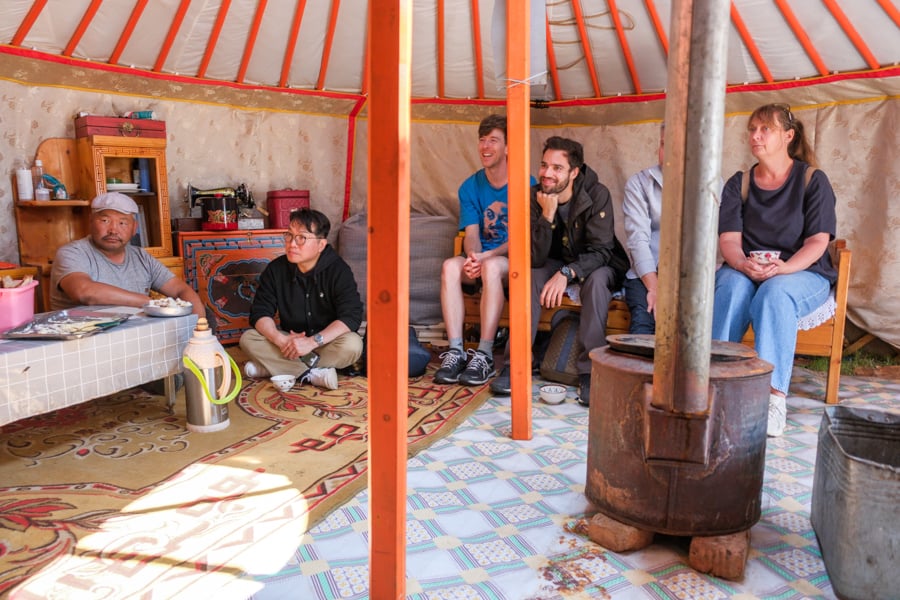 Tourists talking inside a yurt