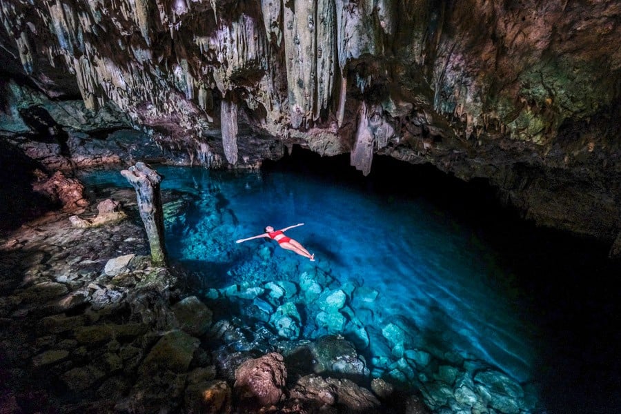 Woman floating in Goa Rangko cave near Labuan Bajo