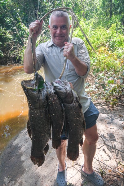 Tourist holding some big anjumara fish