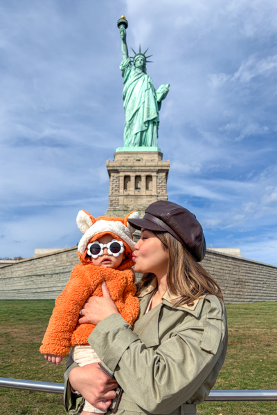 Posing with the Statue of Liberty in New York City