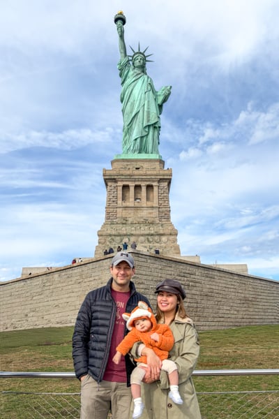 Posing with the Statue of Liberty in New York City